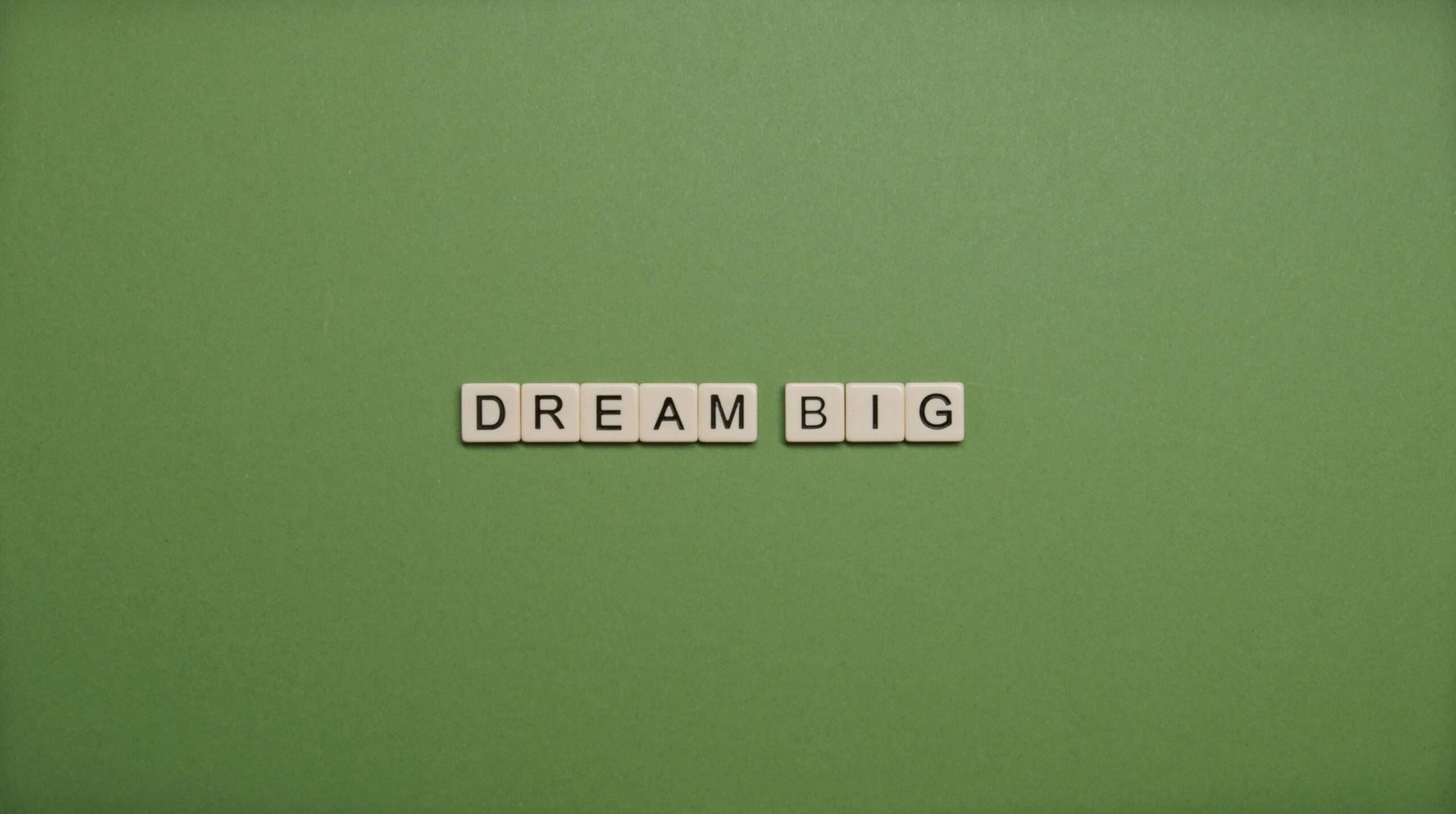 Scrabble letters that spell out "Dream Big"