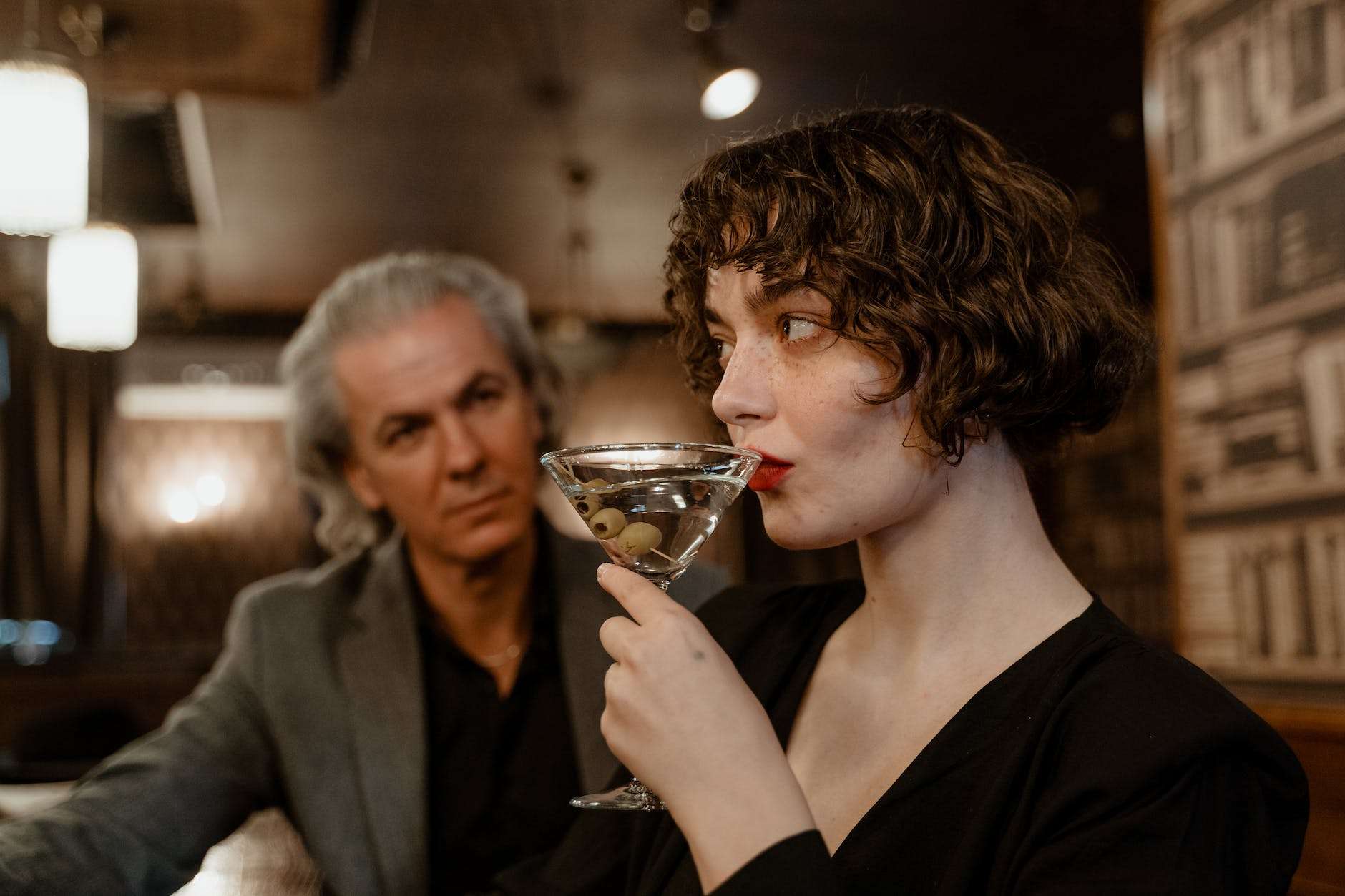 a woman drinking cocktail