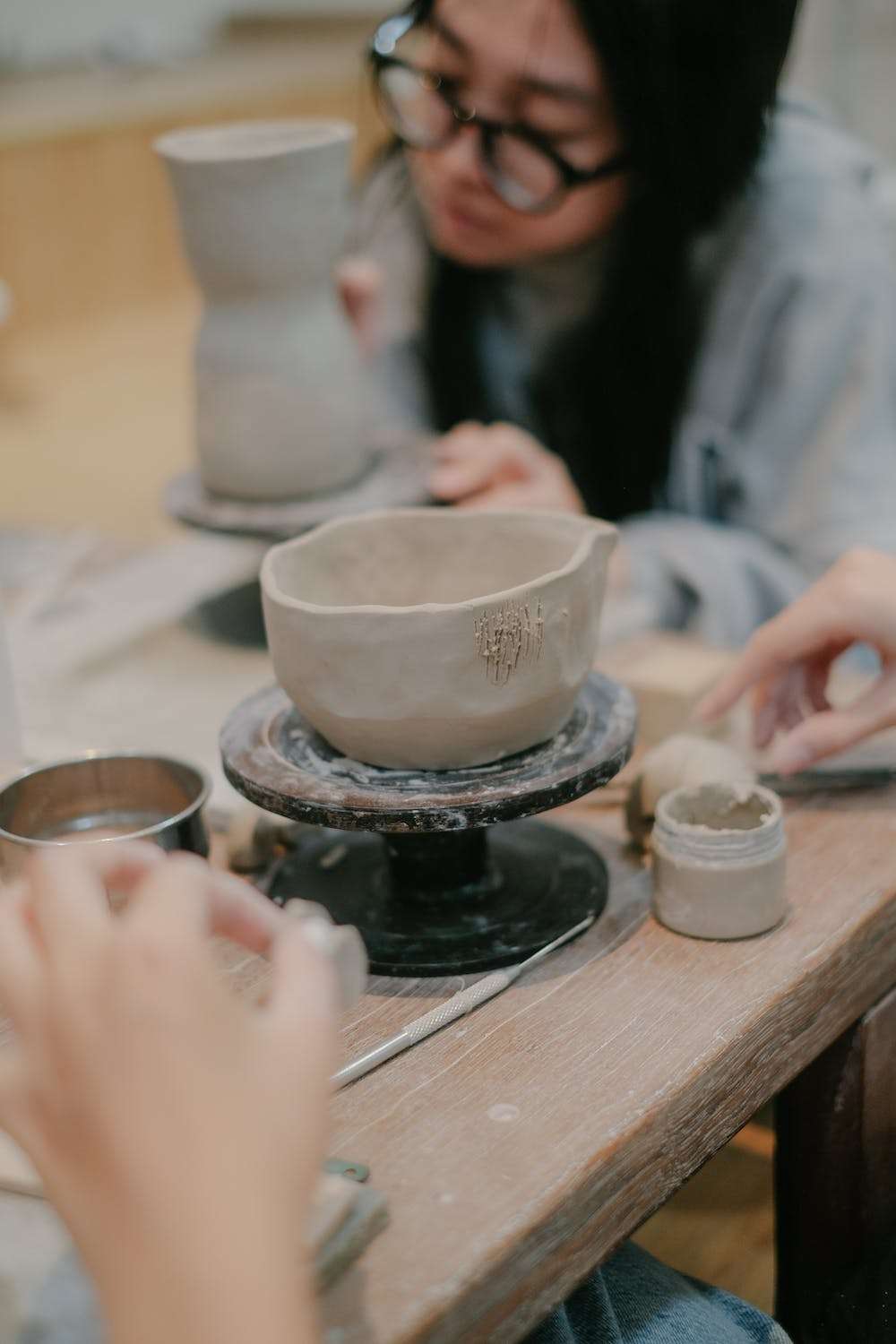Try something new to improve your mental health photo of woman making pottery