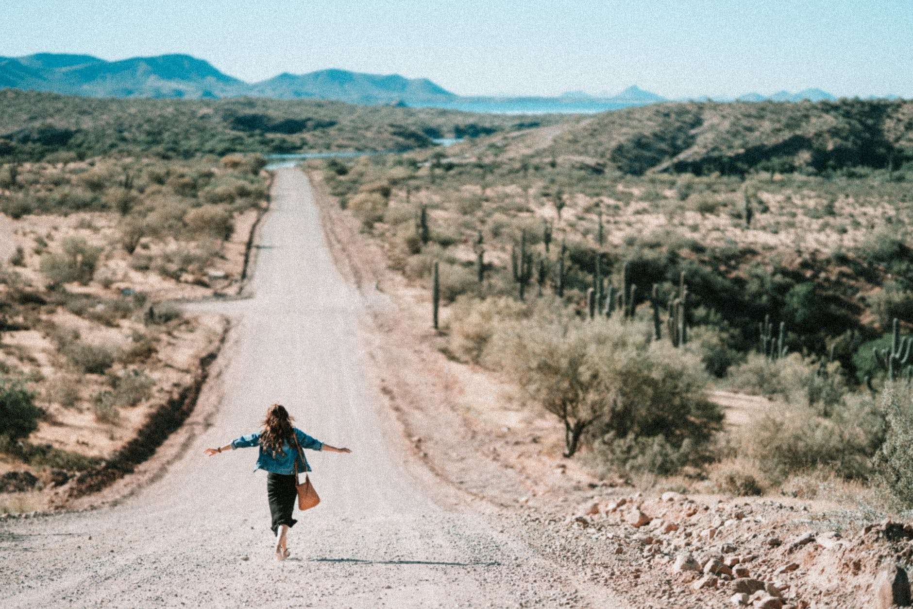 woman walking on dirt road