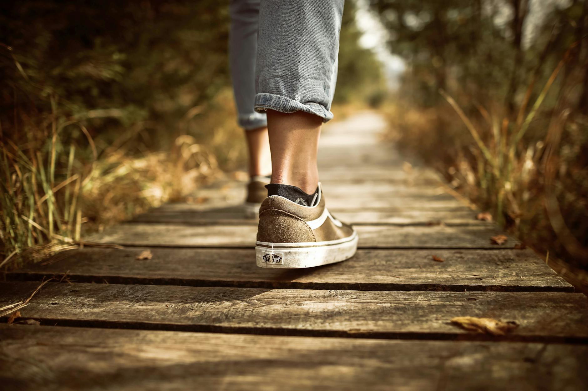 person stands on brown pathway