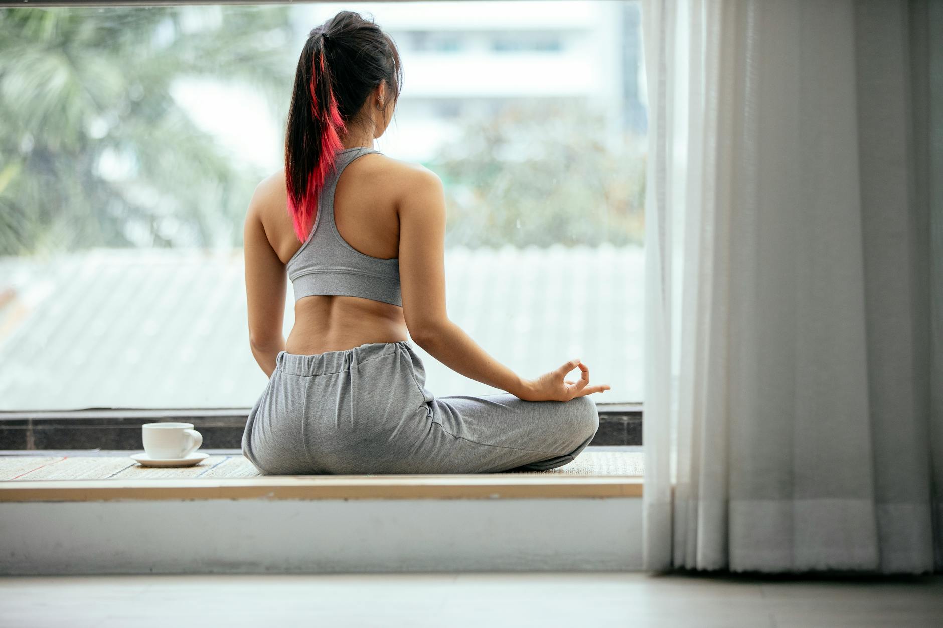 relaxed woman meditating in padmasana