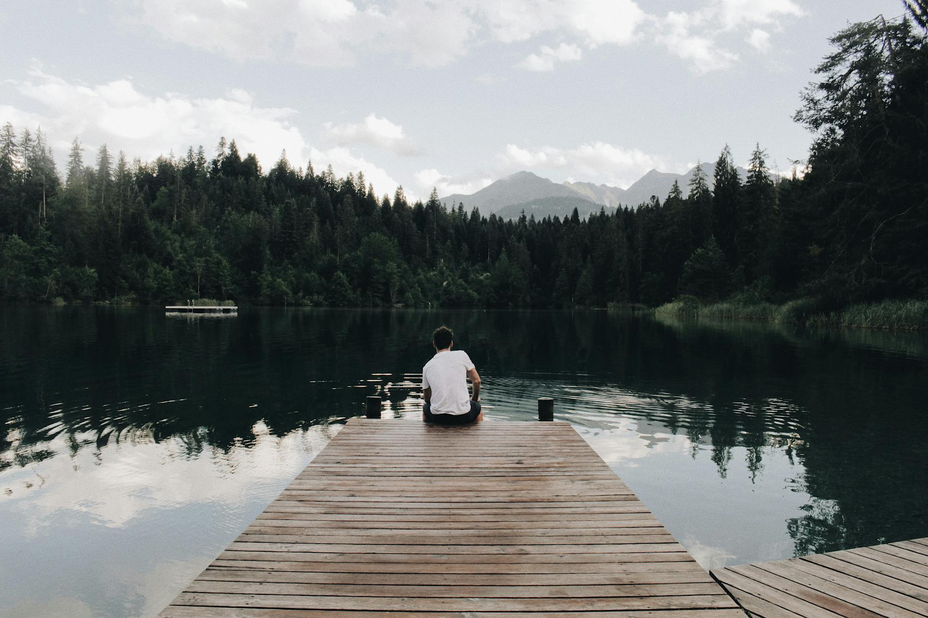 man sitting on dock