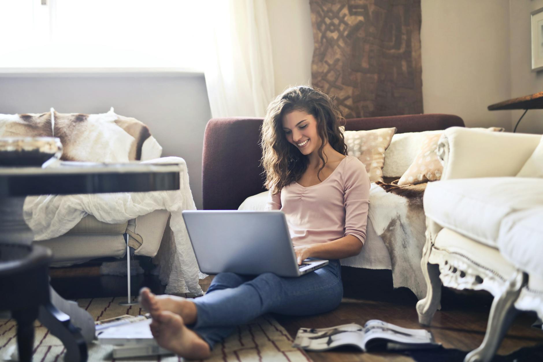 woman smiling while using laptop