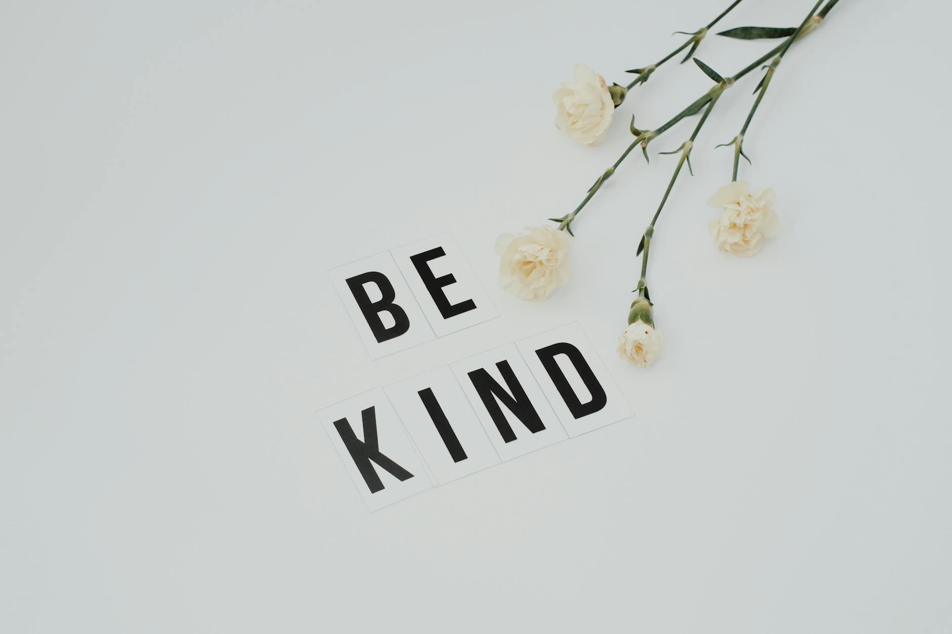 be kind lettering on white surface