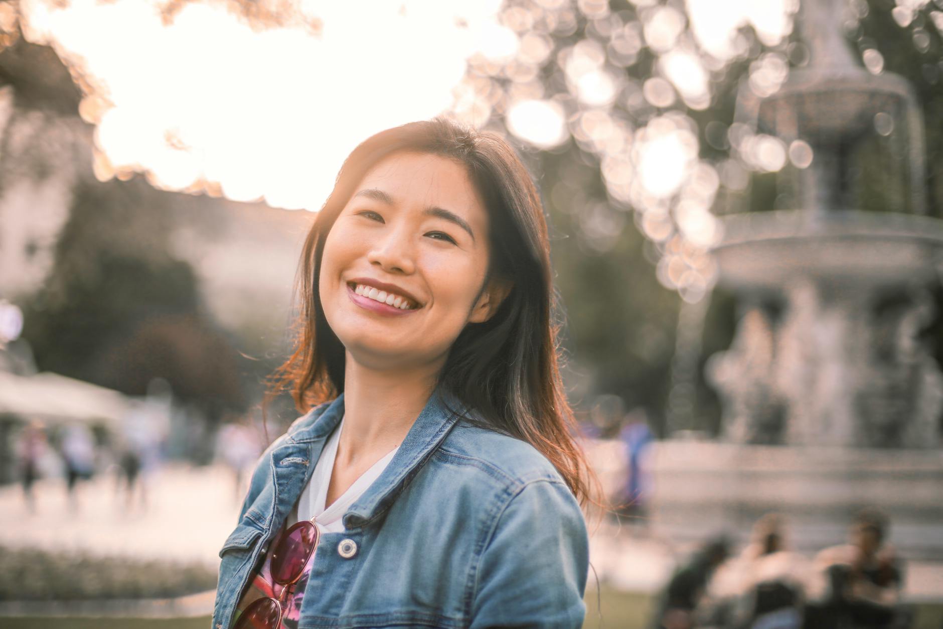 smiling woman in blue denim jacket
