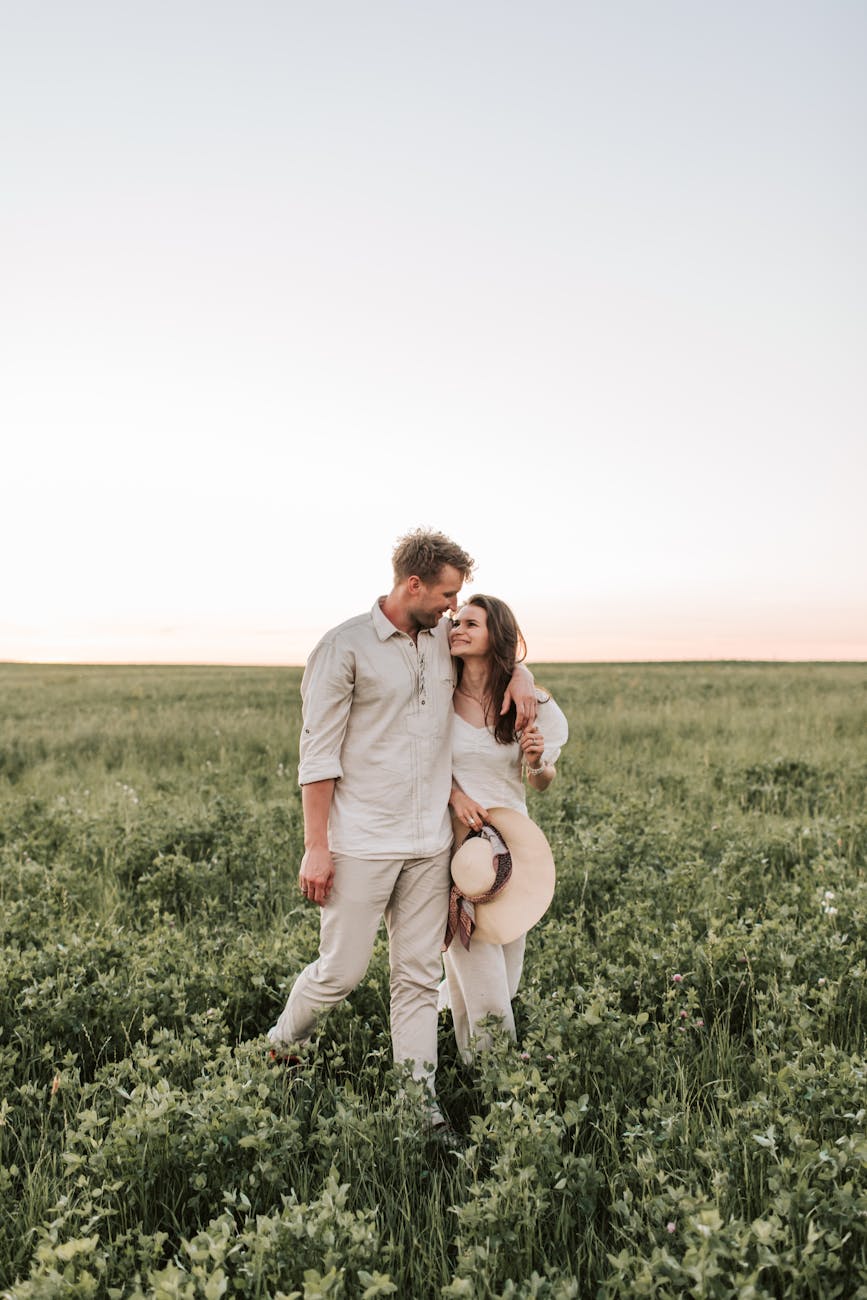 a couple walking on the grass field