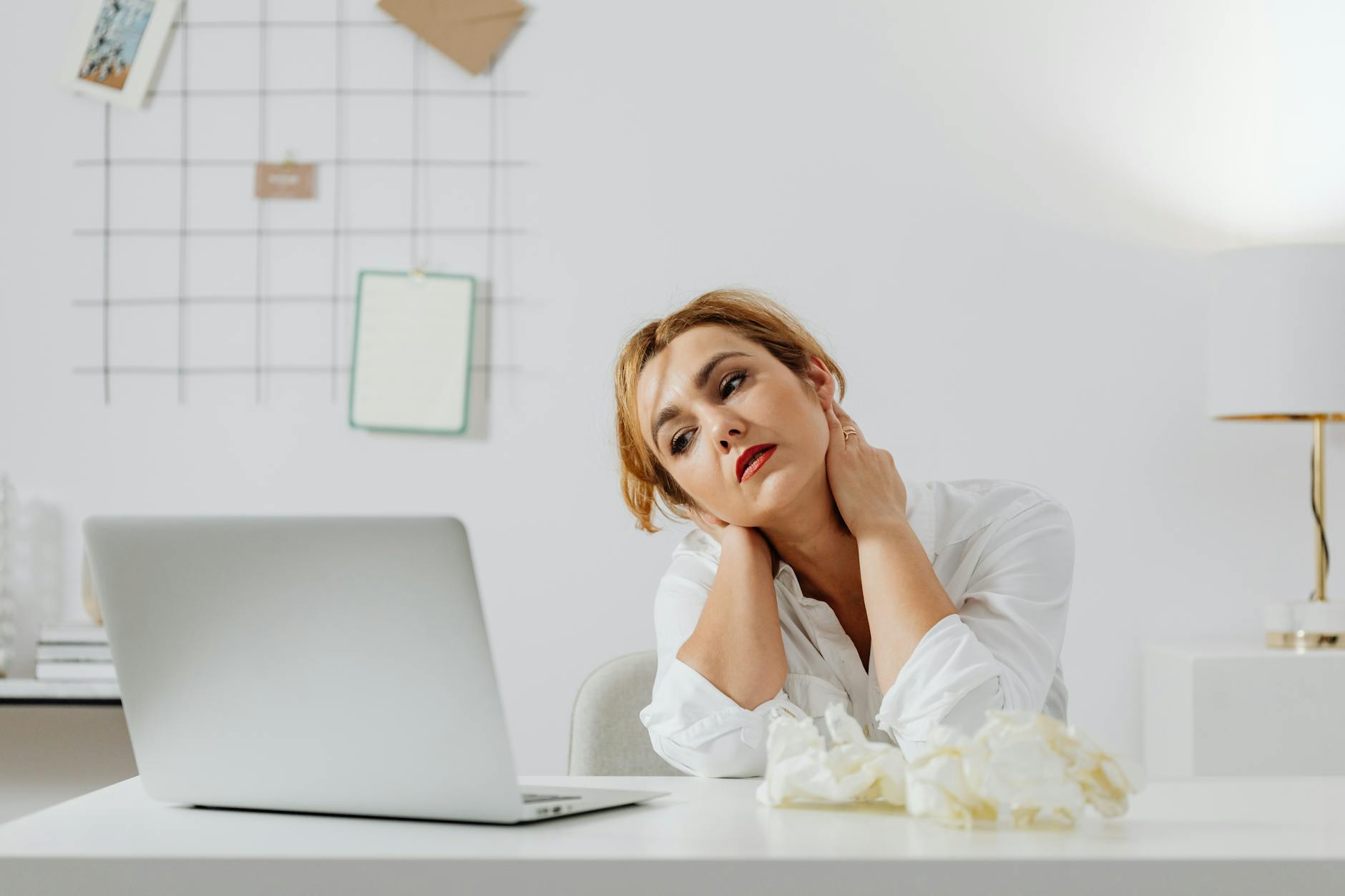 a bored woman looking at the macbook laptop