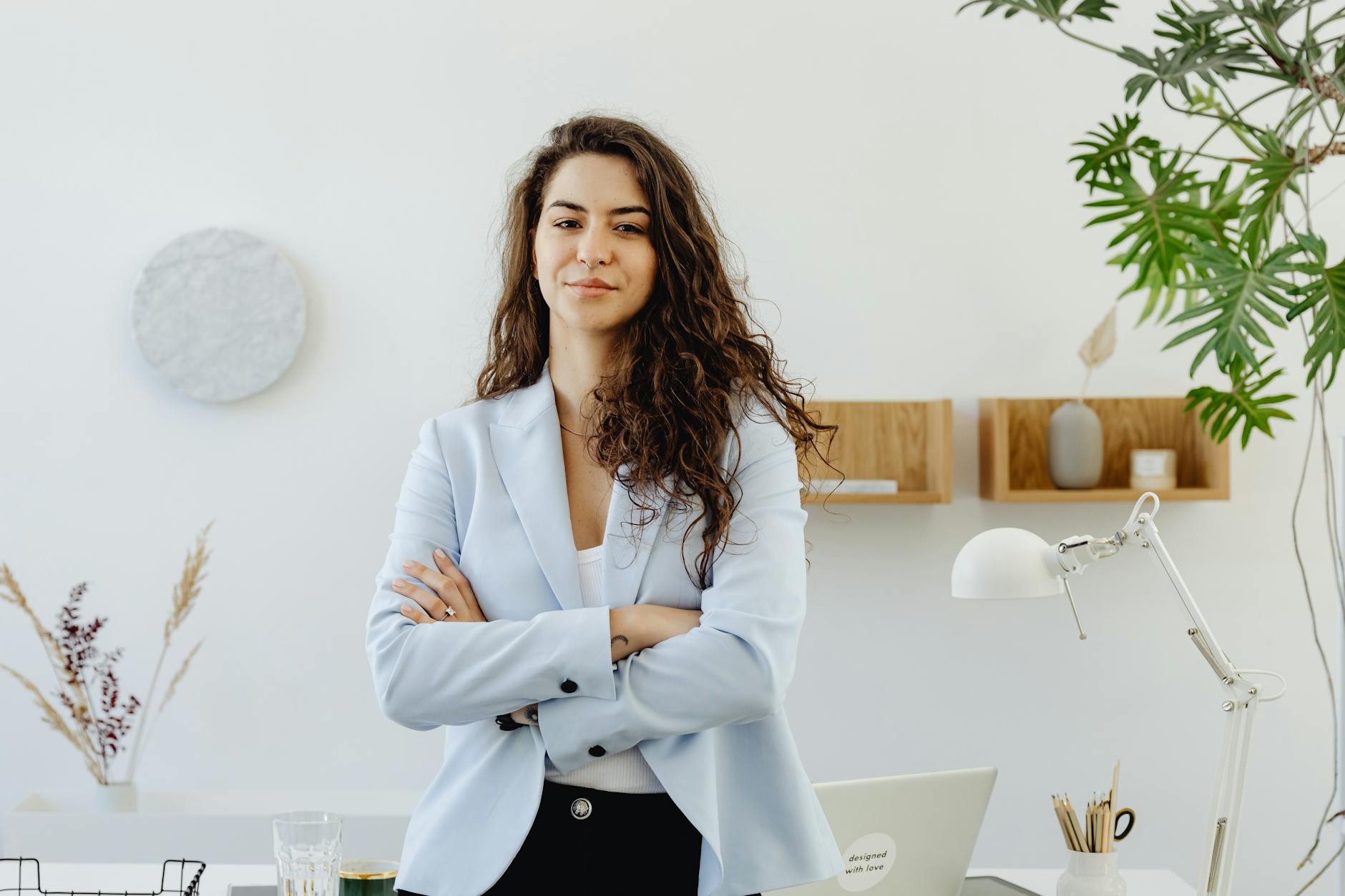 woman in sky blue blazer standing near white wall