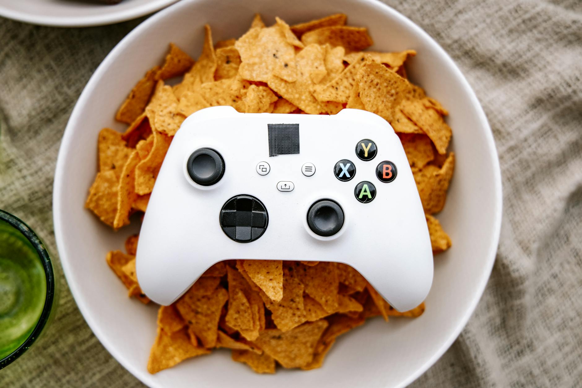 white game controller on bowl of chips