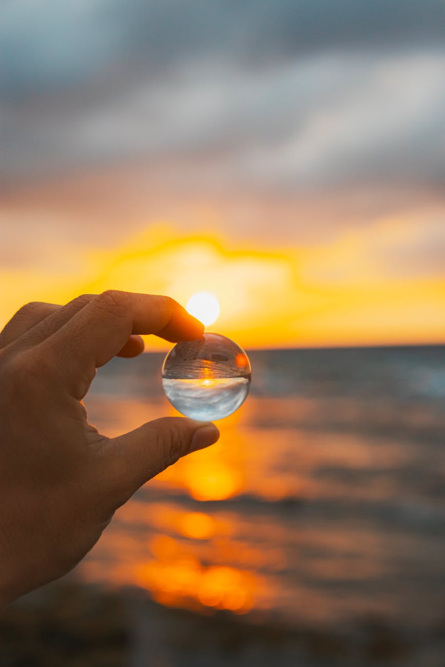 a person holding a glass ball