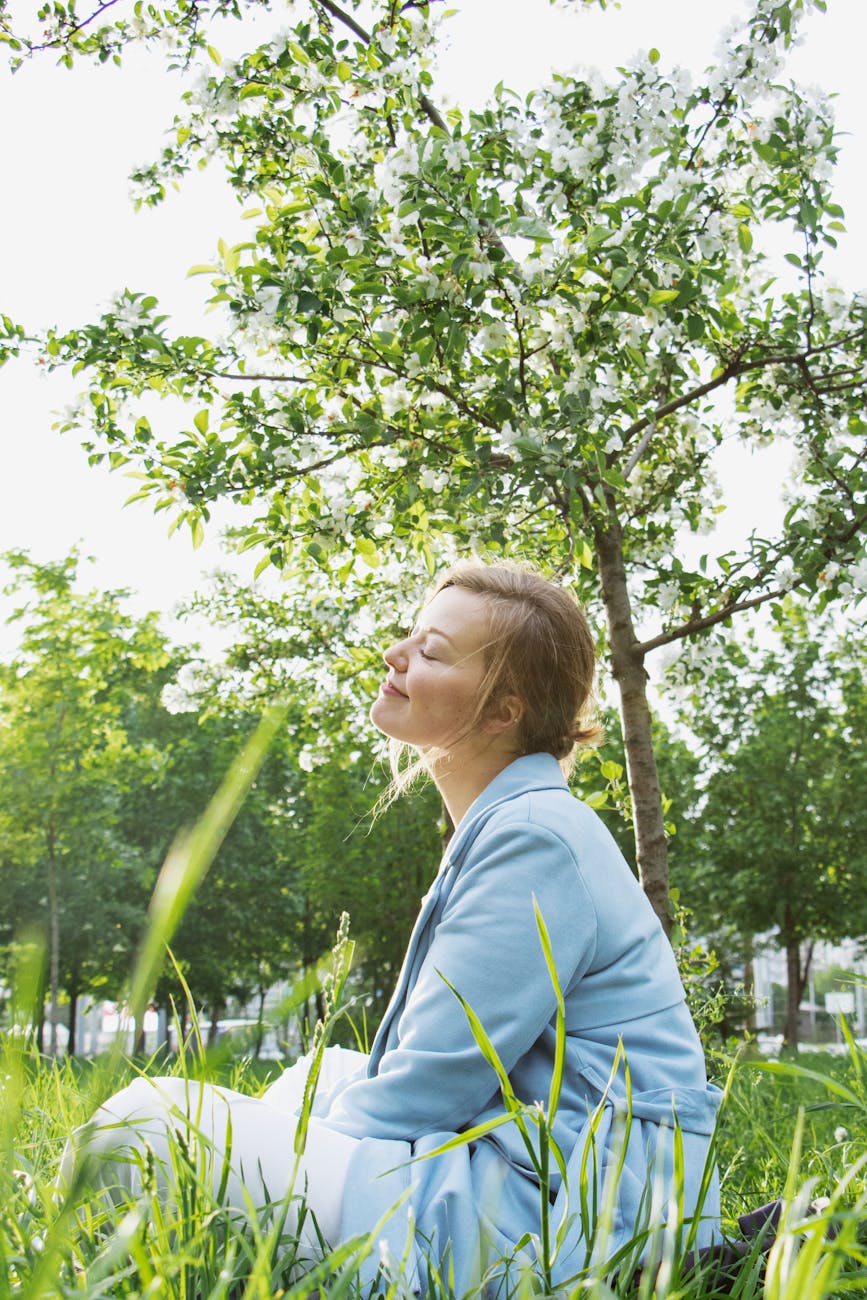 woman in blue blazer sitting on gras field