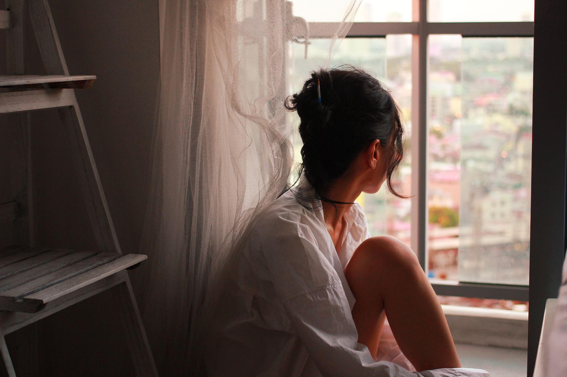 woman looking out of window