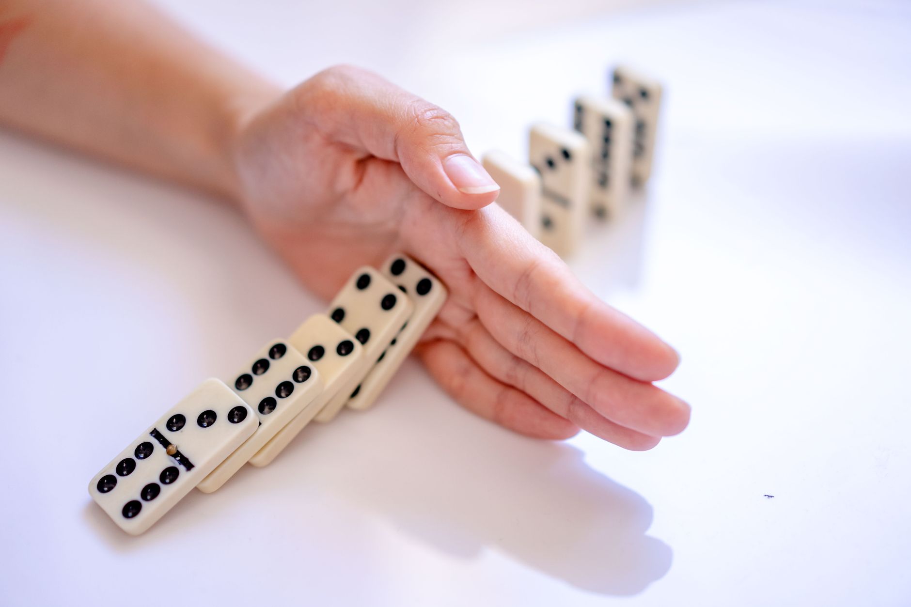 woman hand stopping domino dice