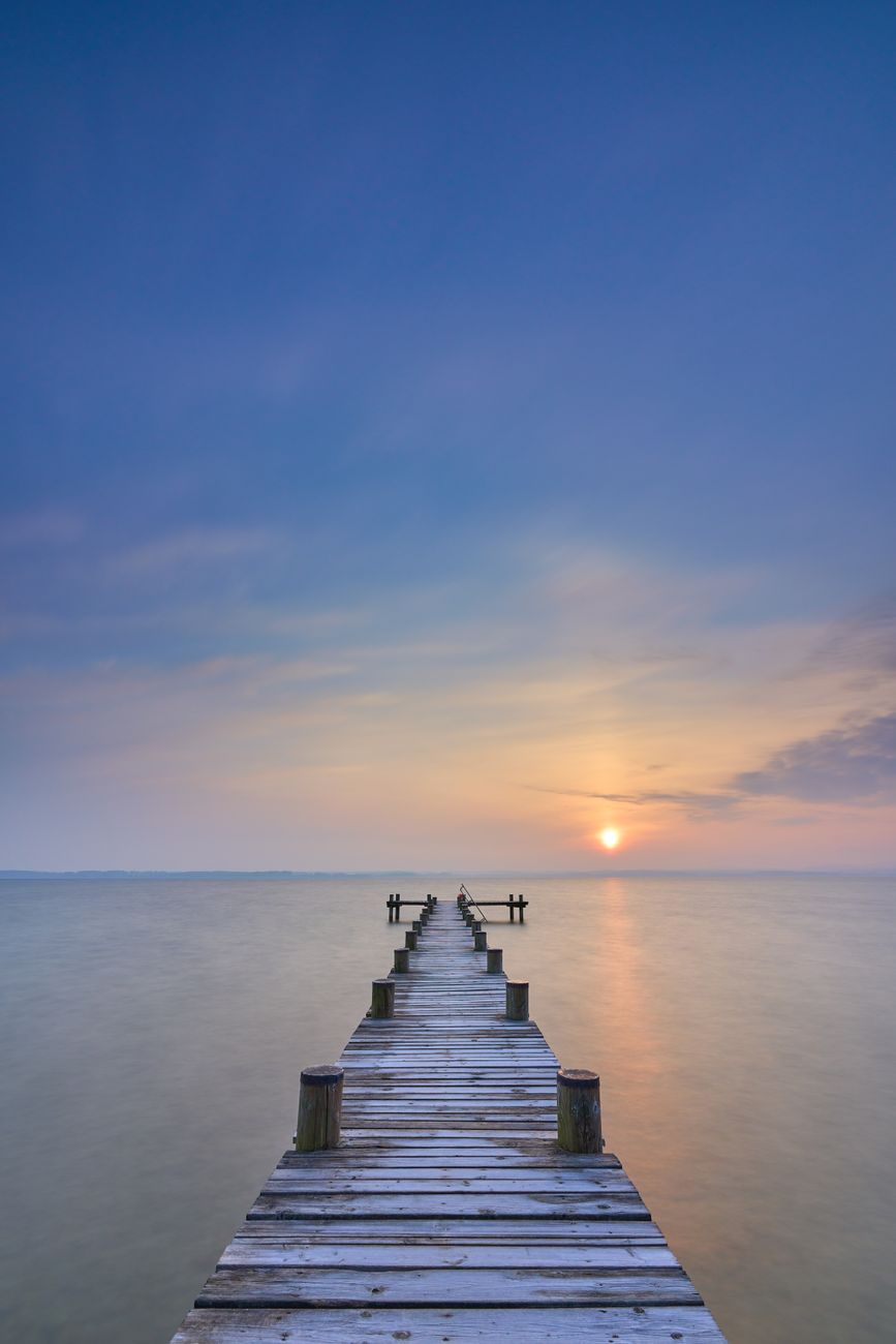 tranquil sunrise over bavarian lake pier