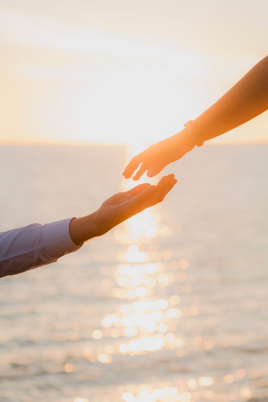 romantic hand reach at sunset in sinaloa