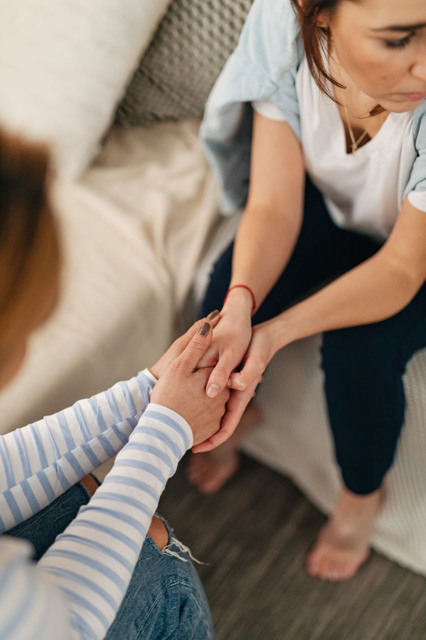 high angle shot of women holding hands